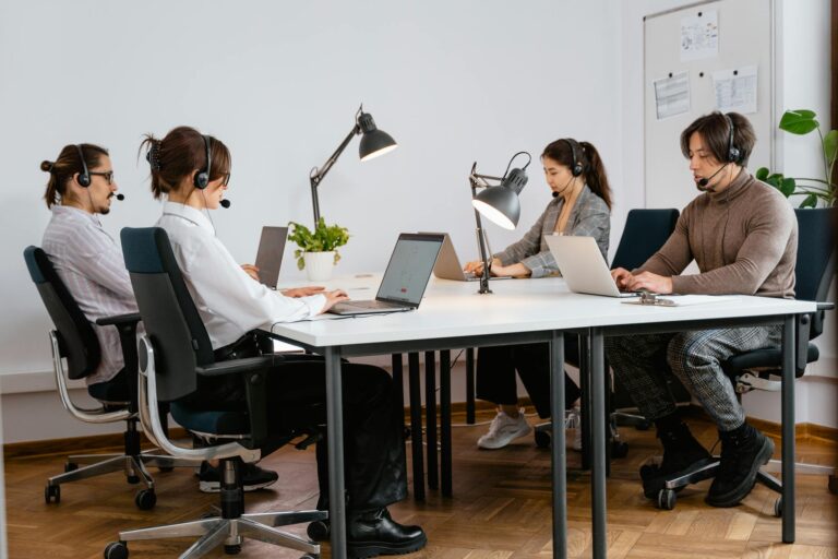 Team of diverse call center agents working diligently in a modern office setting.